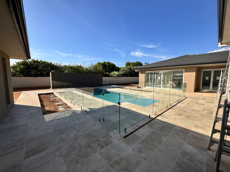 Modern frameless glass pool barrier installed at a Yoogali property